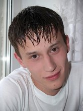 Sweaty/greasy-looking twink undressing next to a window