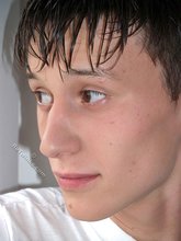 Sweaty/greasy-looking twink undressing next to a window