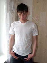 Sweaty/greasy-looking twink undressing next to a window