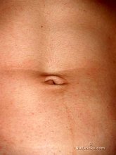 Sweaty/greasy-looking twink undressing next to a window