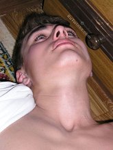 Blue-eyed twink laying on the floor and getting naked