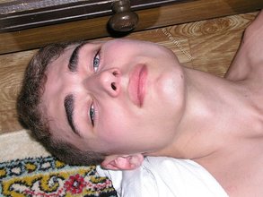Blue-eyed twink laying on the floor and getting naked