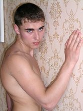 Blue-eyed twink laying on the floor and getting naked