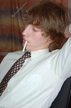 Curly-haired twink smokes a lot and gets fingered
