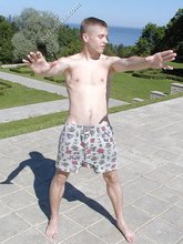 Young blonde twink poses with his cock hanging out outdoors