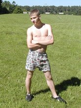 Young blonde twink poses with his cock hanging out outdoors