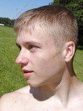 Young blonde twink poses with his cock hanging out outdoors