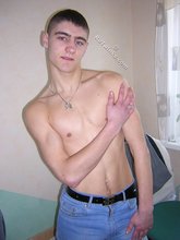 Short-haired twink taking off his blue jeans