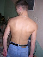 Short-haired twink taking off his blue jeans