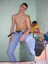 Short-haired twink taking off his blue jeans