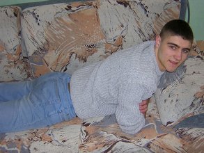 Twink hugs a wall and takes off his shirt
