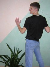 Twink hugs a wall and takes off his shirt