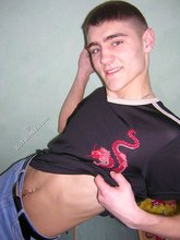 Twink hugs a wall and takes off his shirt