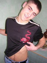 Twink hugs a wall and takes off his shirt