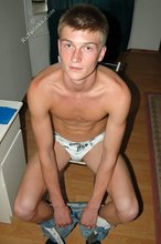 Cheerful gay boy shows off his soft soles to the viewer