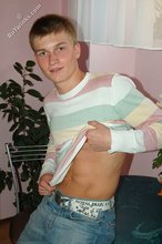 Blue-eyed blonde beauty takes off his striped shirt