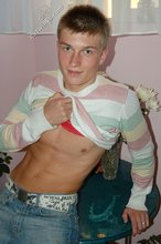 Blue-eyed blonde beauty takes off his striped shirt
