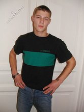 Cute twink poses in a black t-shirt and skinny jeans
