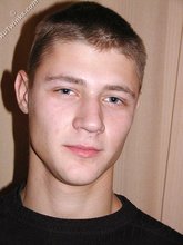 Cute twink poses in a black t-shirt and skinny jeans