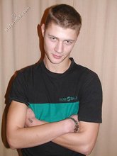 Cute twink poses in a black t-shirt and skinny jeans