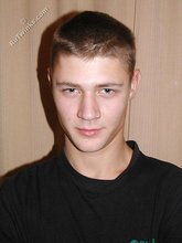Cute twink poses in a black t-shirt and skinny jeans
