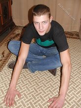 Cute twink poses in a black t-shirt and skinny jeans