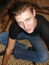 Cute twink poses in a black t-shirt and skinny jeans