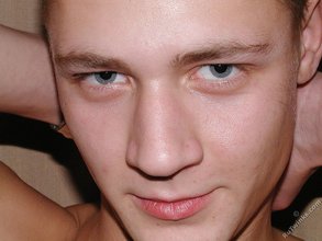 Blue-eyed twink shows his tattoos and hairy armpits