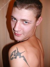Blue-eyed twink shows his tattoos and hairy armpits