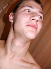 Blue-eyed twink shows his tattoos and hairy armpits