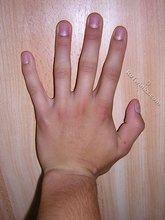 Young boy shows his hands, feet and athletic body