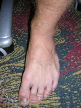 Young boy shows his hands, feet and athletic body