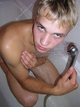 Muscular twink blonde washing his perfect body