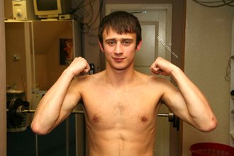 Blue-eyed gay boy happily undressing on camera