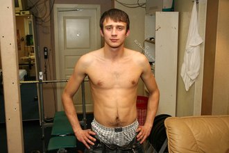 Blue-eyed gay boy happily undressing on camera