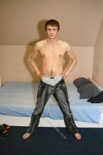 Blue-eyed gay boy happily undressing on camera