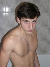 Dark-haired twink takes off his underwear in the bathroom