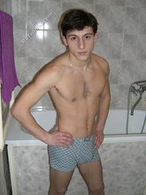 Dark-haired twink takes off his underwear in the bathroom