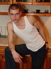 Bald-headed dude in a wife-beater gets almost naked