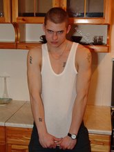Bald-headed dude in a wife-beater gets almost naked