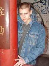 Denim-loving guy posing outdoors, looking mean/lean