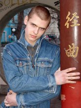 Denim-loving guy posing outdoors, looking mean/lean