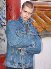 Denim-loving guy posing outdoors, looking mean/lean