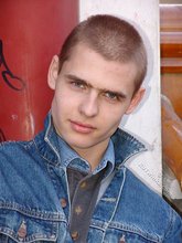 Denim-loving guy posing outdoors, looking mean/lean