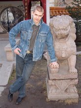 Denim-loving guy posing outdoors, looking mean/lean