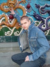 Denim-loving guy posing outdoors, looking mean/lean