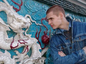 Denim-loving guy posing outdoors, looking mean/lean