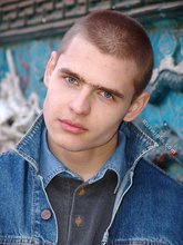 Denim-loving guy posing outdoors, looking mean/lean