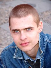 Denim-loving guy posing outdoors, looking mean/lean