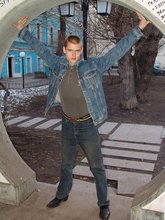 Denim-loving guy posing outdoors, looking mean/lean